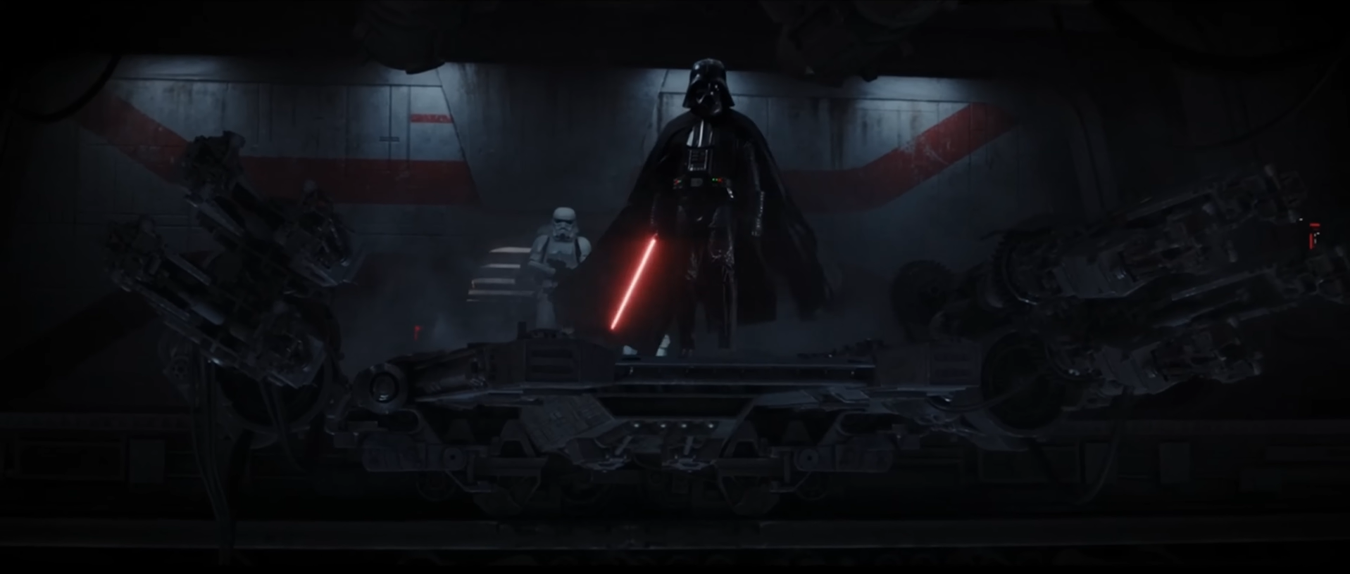 A cinematic wide shot featuring Darth Vader standing on a metallic platform with his red lightsaber ignited, flanked by a Stormtrooper in a dark, industrial hangar environment.